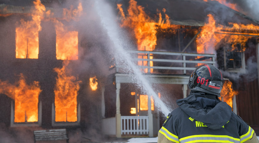 A firefighter fighting a burning building