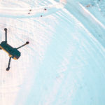 A drone flying over snow